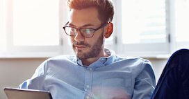 Young Man With Glasses On Computer